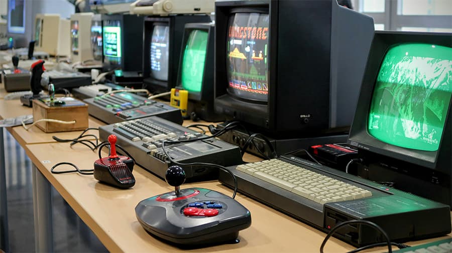 A row of computers on desk for gaming